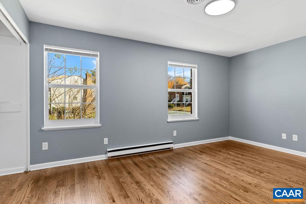 904 Rockcreek Road Charlottesville, VA 22903 - Photo 17 of 25 an empty room with wooden floor and windows