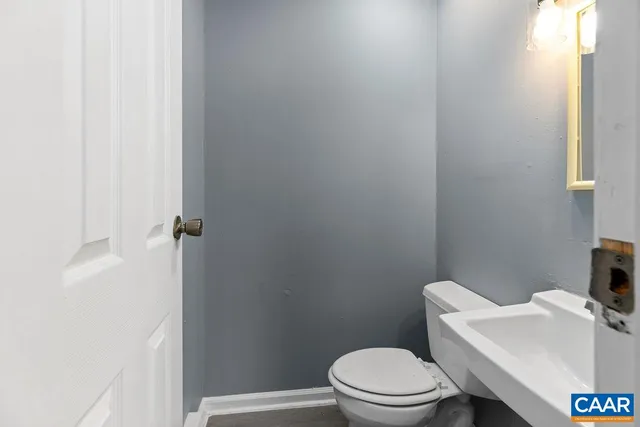 a white toilet sitting next to a bathroom sink