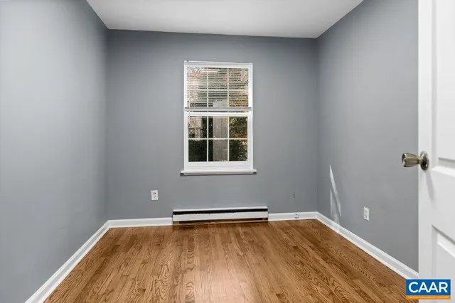 a view of a room with wooden floor and windows