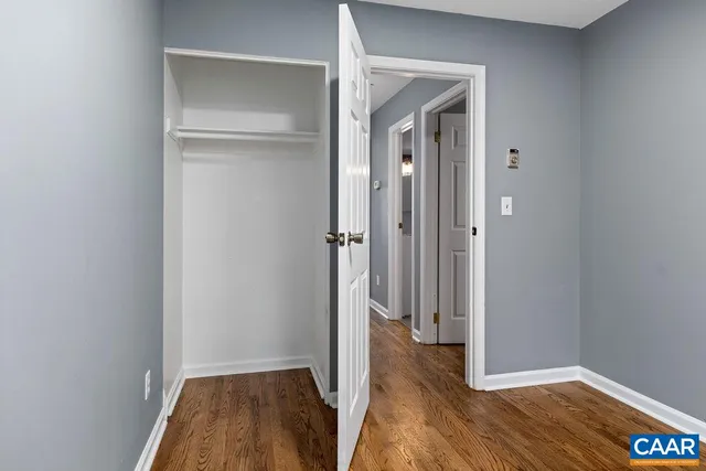 a view of hallway with wooden floor