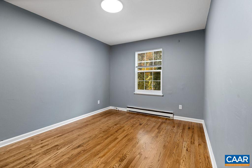 904 Rockcreek Road Charlottesville, VA 22903 - Photo 24 of 25 an empty room with wooden floor and windows