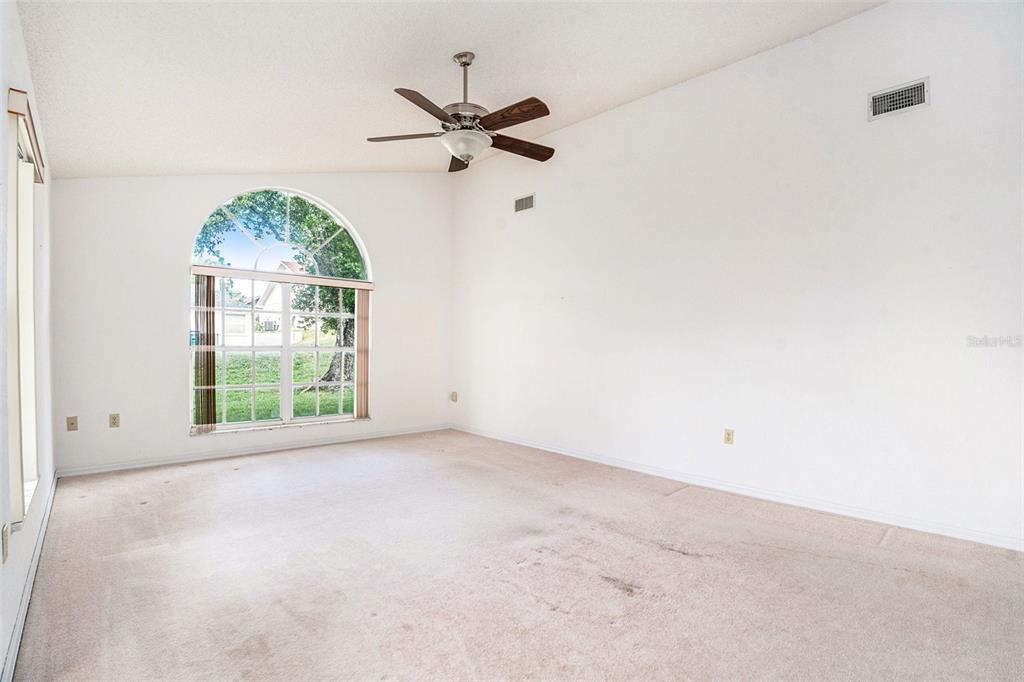 1247 Venetia Drive Spring Hill, FL 34608 - Photo 14 of 27 an empty room with windows and fan