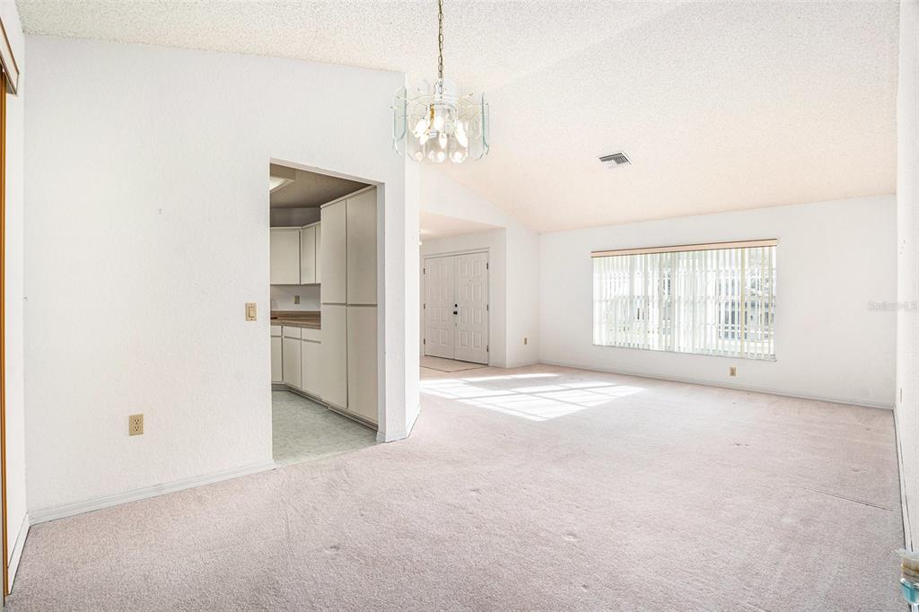 1247 Venetia Drive Spring Hill, FL 34608 - Photo 15 of 27 an empty room with windows and entrance