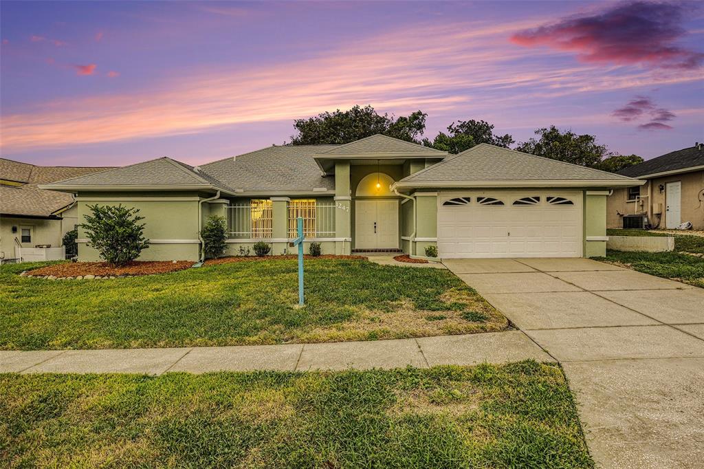 1247 Venetia Drive Spring Hill, FL 34608 - Photo 2 of 27 a front view of a house with a yard