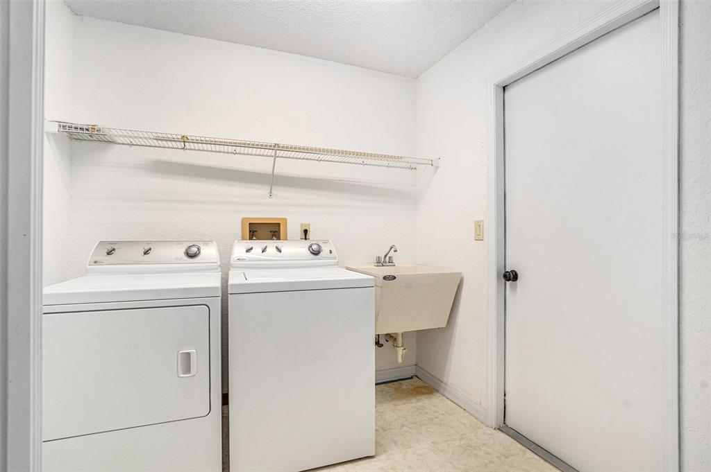 1247 Venetia Drive Spring Hill, FL 34608 - Photo 23 of 27 a utility room with dryer and washer
