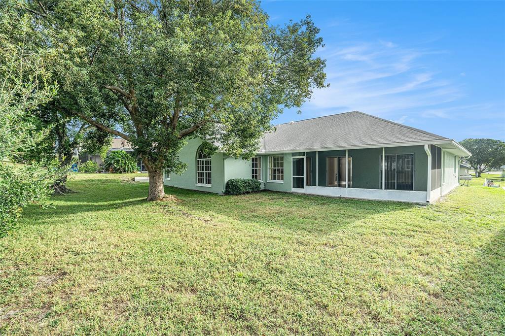 1247 Venetia Drive Spring Hill, FL 34608 - Photo 25 of 27 a front view of a house with a garden