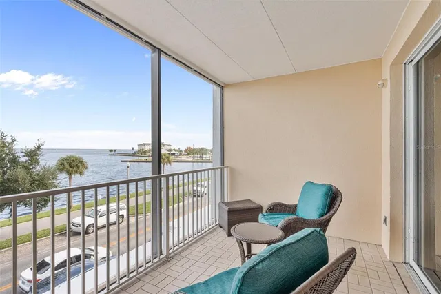a view of a bedroom with a bed and wooden floor