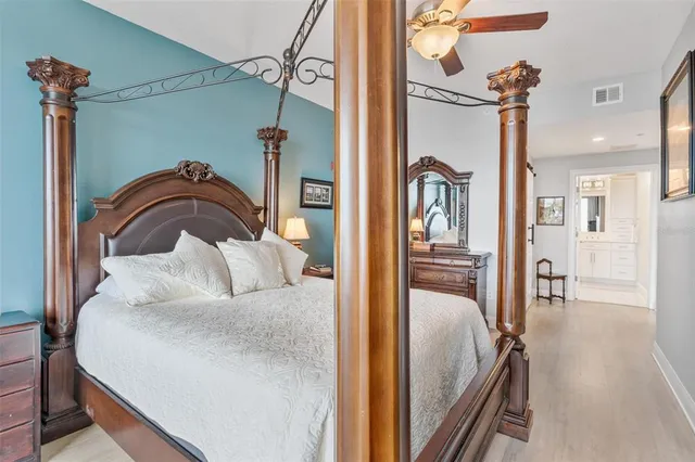 a bedroom with bed and a chandelier