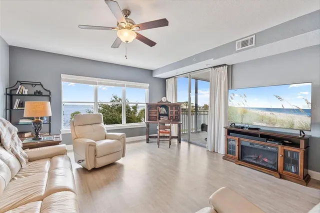 a dining room with furniture a window and wooden floor