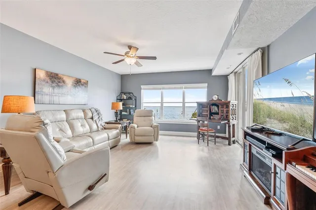 a large kitchen with stainless steel appliances granite countertop a stove refrigerator and cabinets