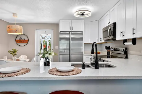 a kitchen with stainless steel appliances kitchen island granite countertop a sink and cabinets