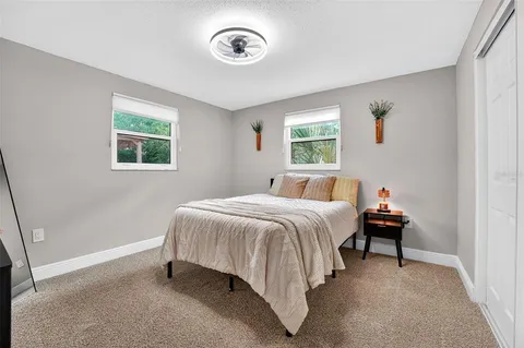 a bedroom with a bed and window