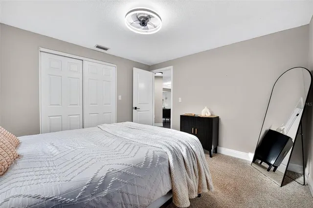 a bedroom with a bed and a television