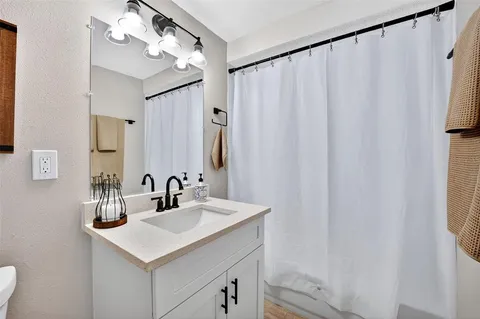 a bathroom with a sink vanity and a mirror
