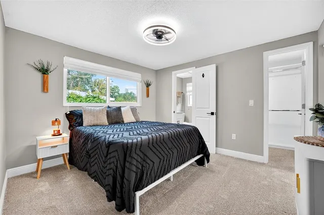 a bed sitting in a bedroom next to a window