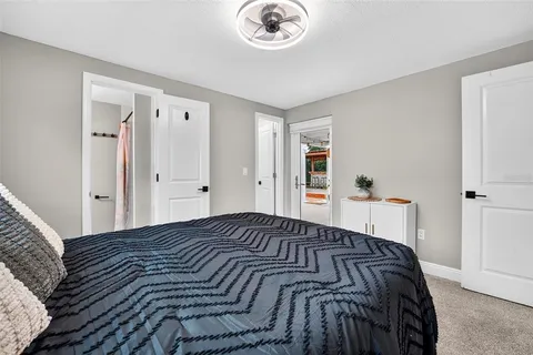 a bedroom with a bed and a chandelier