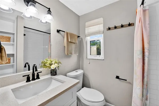 a bathroom with a sink toilet and shower