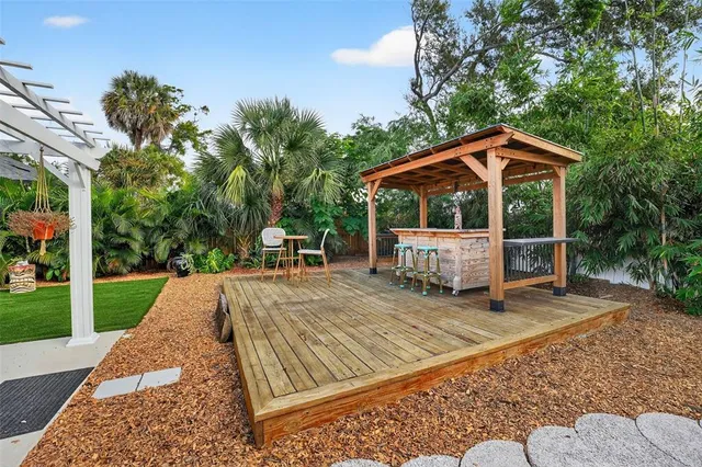 a view of a house with backyard and sitting area