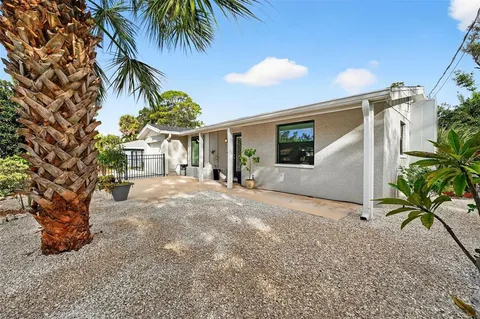 a view of a house with a tree in front of it