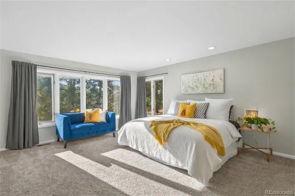 a bedroom with a bed and glass walk in closet