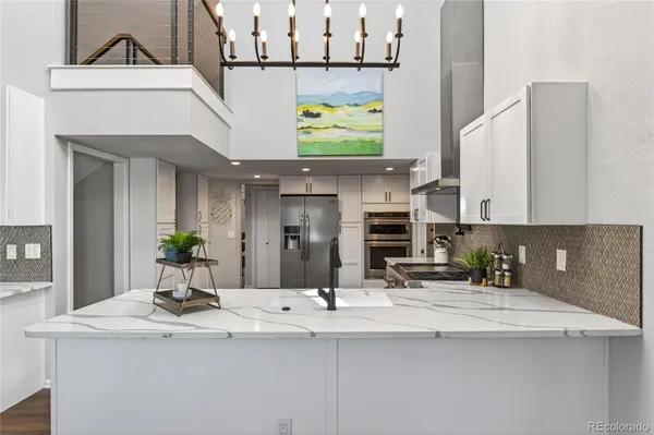 a kitchen with stainless steel appliances kitchen island a sink and cabinets