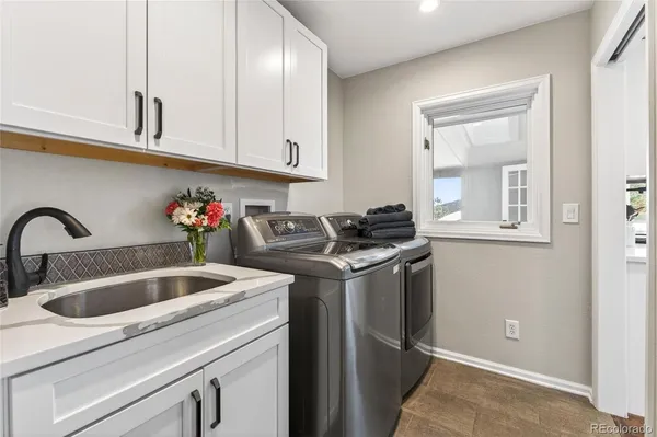 a kitchen with stainless steel appliances granite countertop a sink and cabinets
