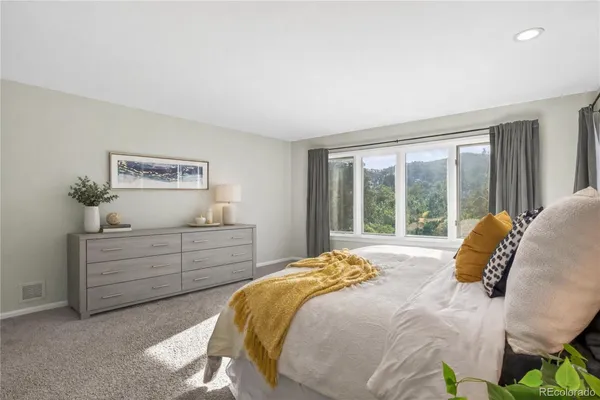 a bed sitting in a bedroom next to a window