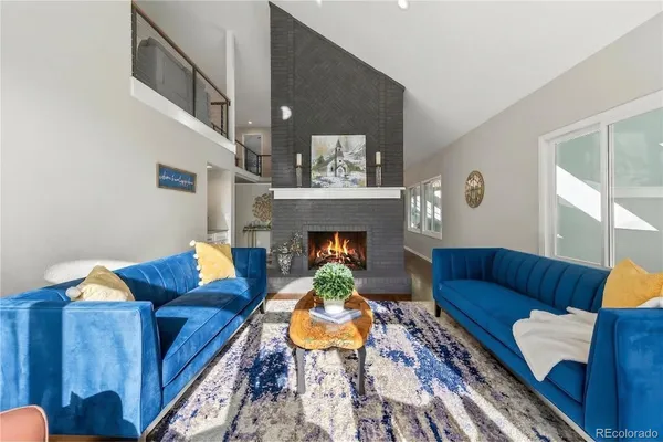 a living room with furniture and a fireplace