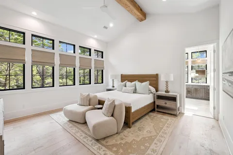 a large bathroom with a tub sink shower and mirror