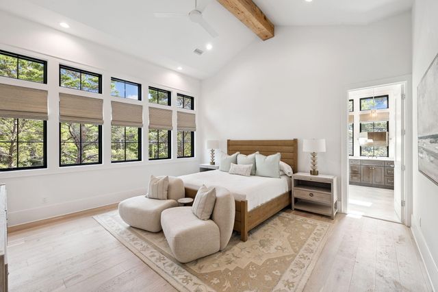 a large bathroom with a tub sink shower and mirror