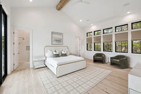 a spacious bathroom with a bathtub shower sink and mirror