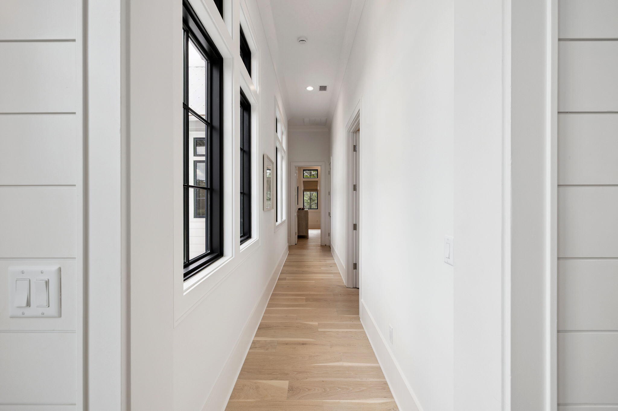 8 Bannerman Beach Lane Santa Rosa Beach, FL 32459 - Photo 19 of 28 a view of a hallway with wooden floor and staircase