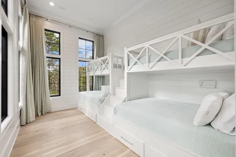 a view of a hallway with a white door and stairs