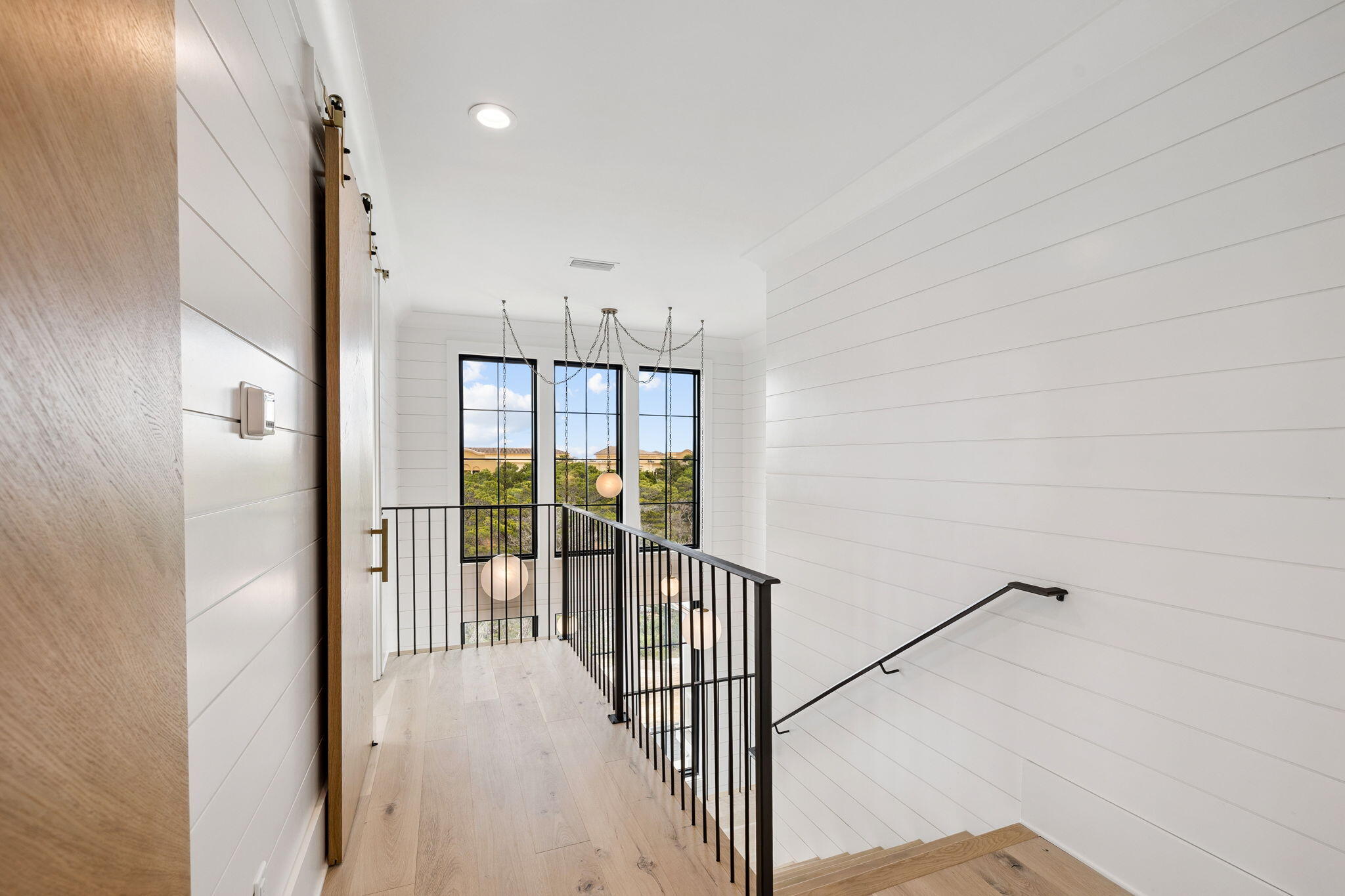 8 Bannerman Beach Lane Santa Rosa Beach, FL 32459 - Photo 22 of 28 a view of a hallway with a white door and stairs