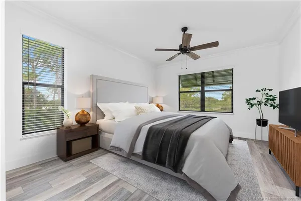 a bedroom with a bed and wooden floor