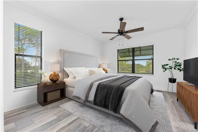 a bedroom with a bed and wooden floor