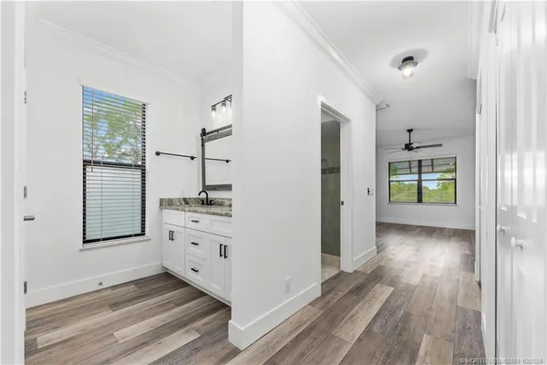 a room view with wooden floor and windows