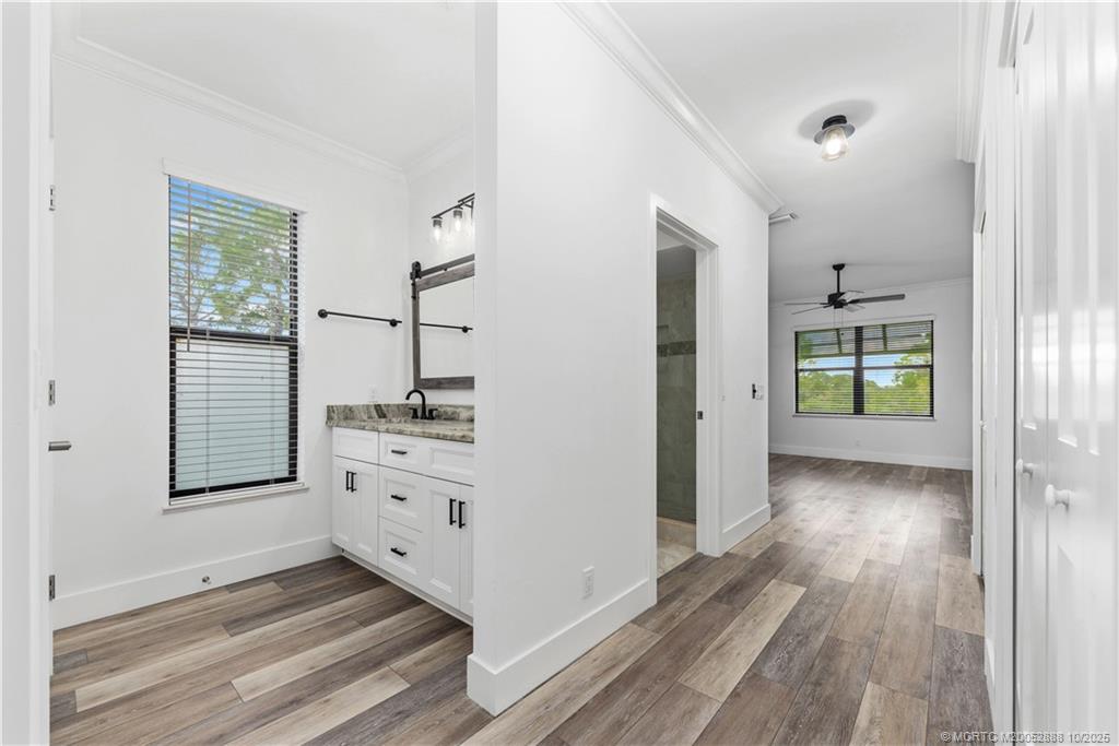 13468 Northwest Harbour Ridge Boulevard, Unit 2A Palm City, FL 34990 - Photo 19 of 38 a room view with wooden floor and windows