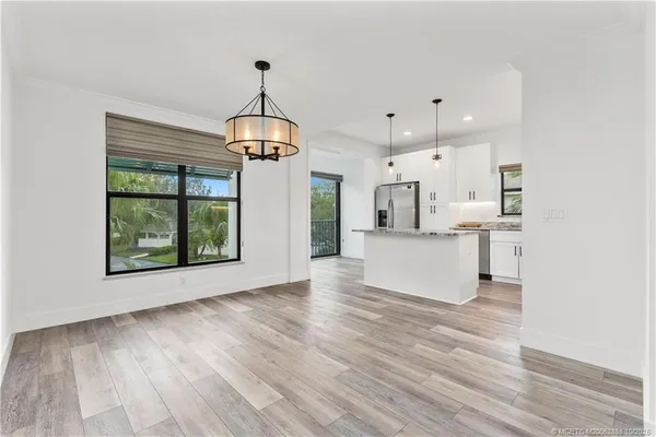 a view of large kitchen with wooden floor and window