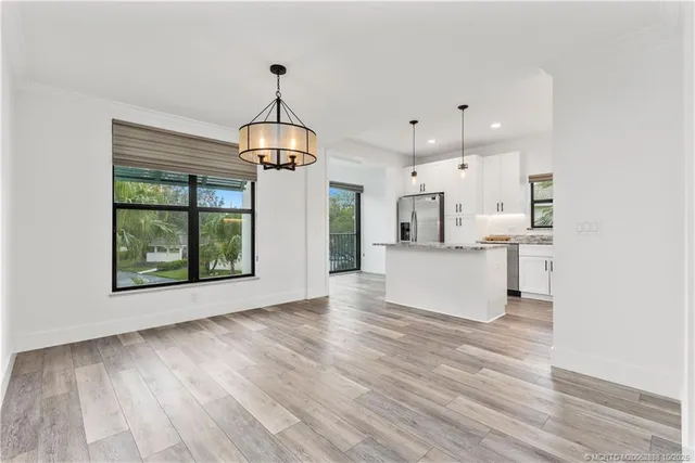 a view of large kitchen with wooden floor and window