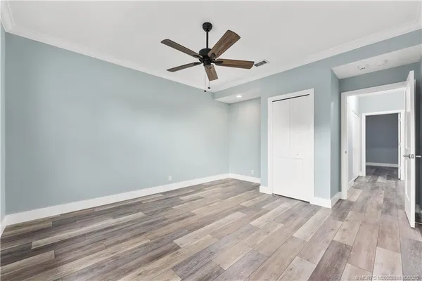 a view of a hallway with wooden floor