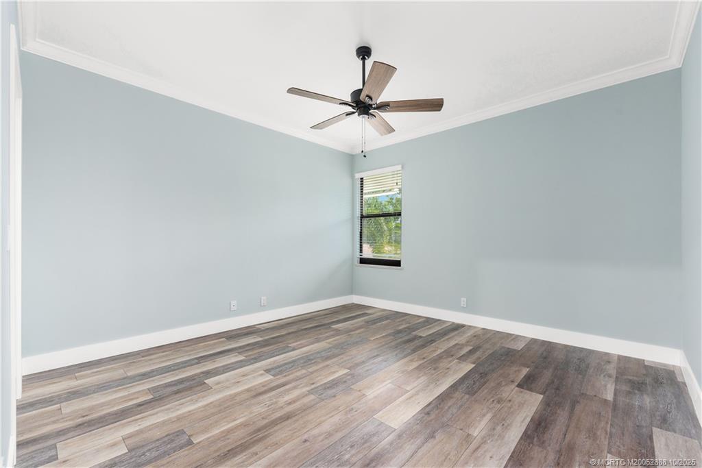13468 Northwest Harbour Ridge Boulevard, Unit 2A Palm City, FL 34990 - Photo 25 of 38 an empty room with windows and fan