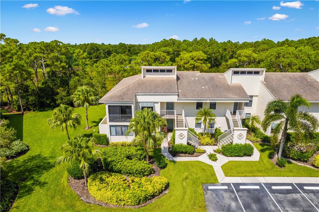13468 Northwest Harbour Ridge Boulevard, Unit 2A Palm City, FL 34990 - Photo 32 of 38 an aerial view of a house with garden space and outdoor seating