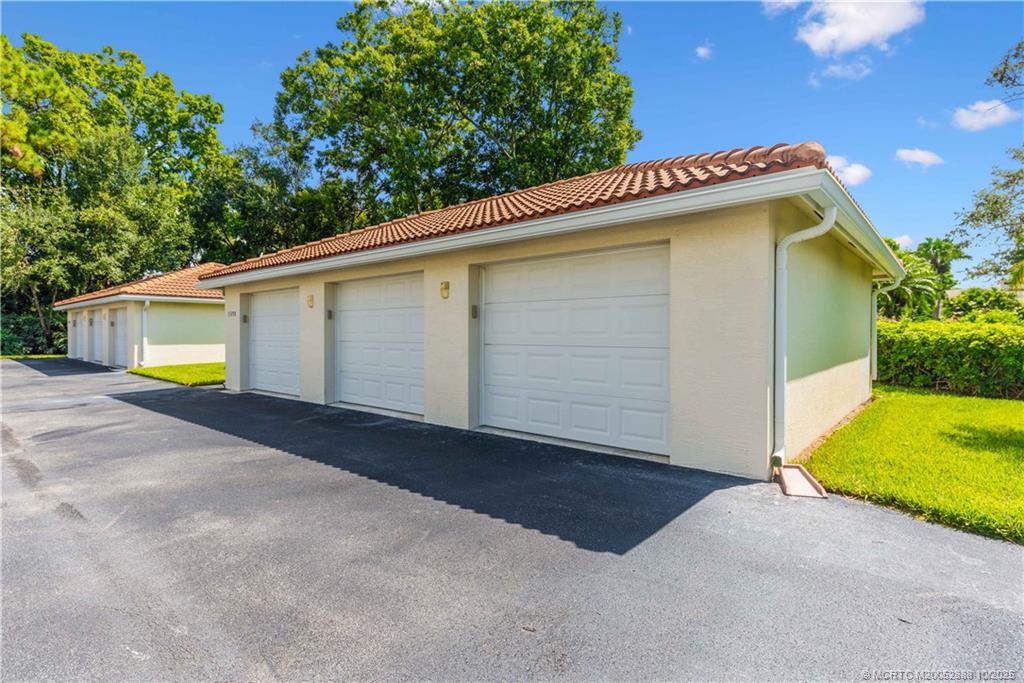 13468 Northwest Harbour Ridge Boulevard, Unit 2A Palm City, FL 34990 - Photo 38 of 38 a view of a garage with a backyard