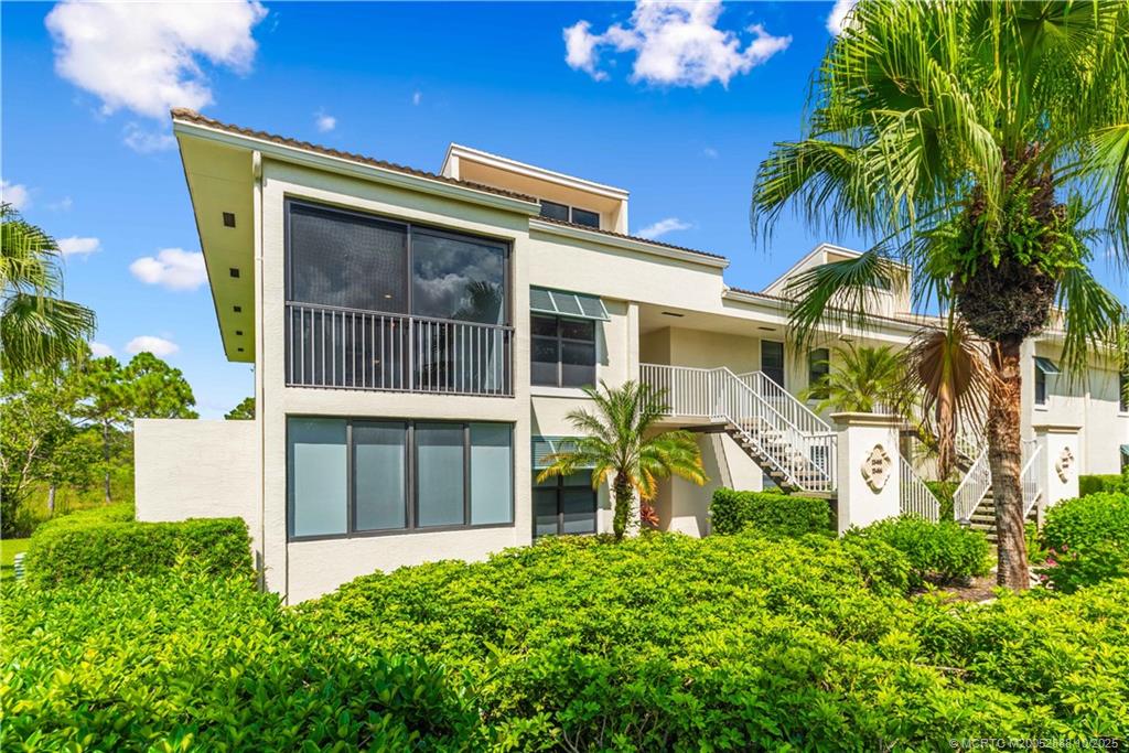 13468 Northwest Harbour Ridge Boulevard, Unit 2A Palm City, FL 34990 - Photo 4 of 38 a front view of a house with a yard