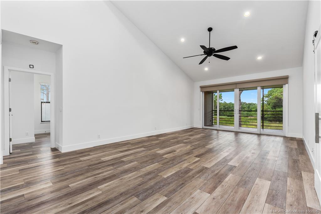 13468 Northwest Harbour Ridge Boulevard, Unit 2A Palm City, FL 34990 - Photo 8 of 38 a view of empty room with wooden floor and fan