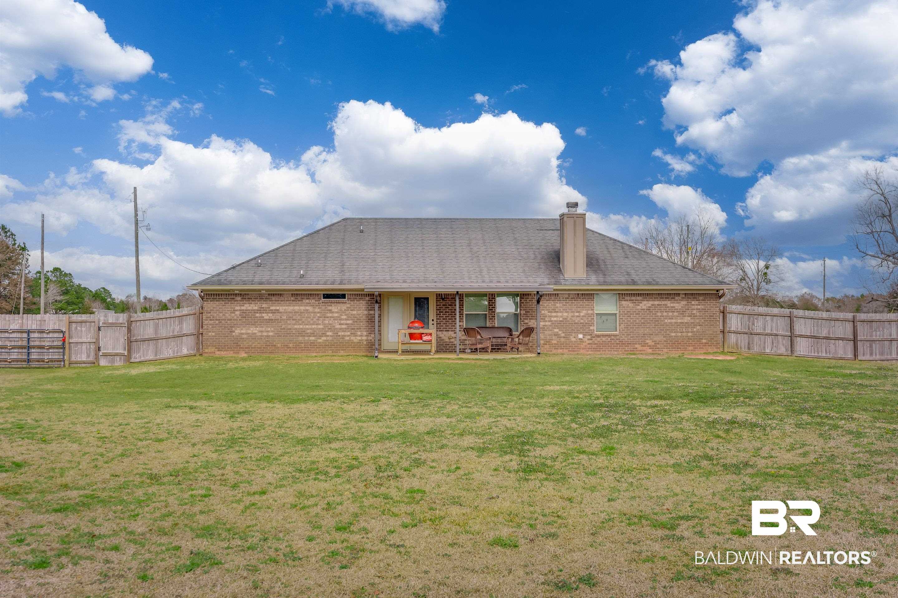 13235 Tom Gaston Road Mobile, AL 36695 - Photo 31 of 43 Back of property with a yard and a patio area