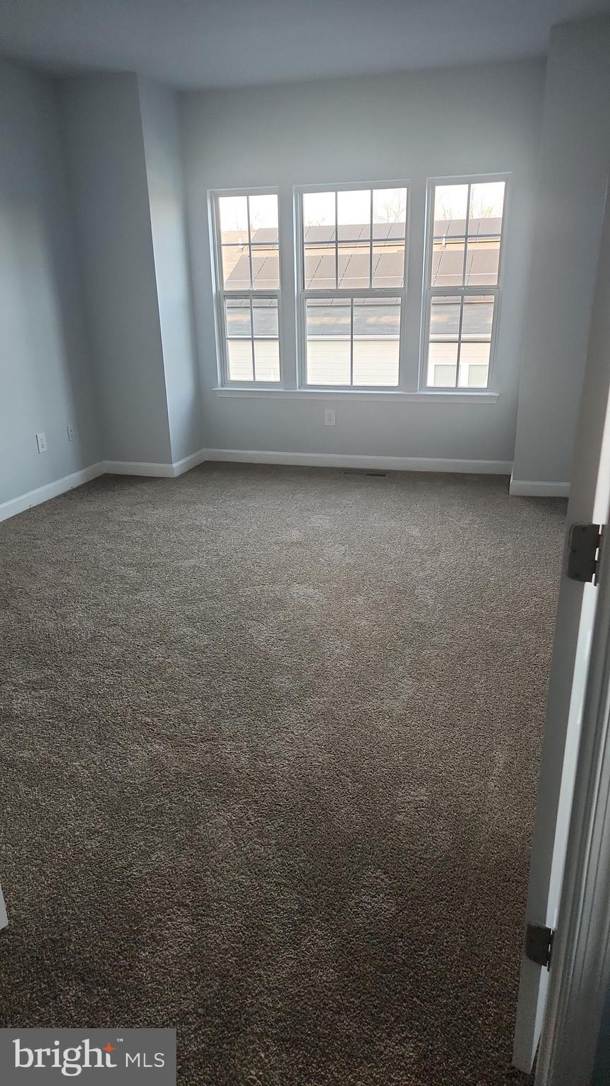 11612 Leesborough Circle Silver Spring, MD 20902 - Photo 19 of 29 an empty room with wooden floor and windows