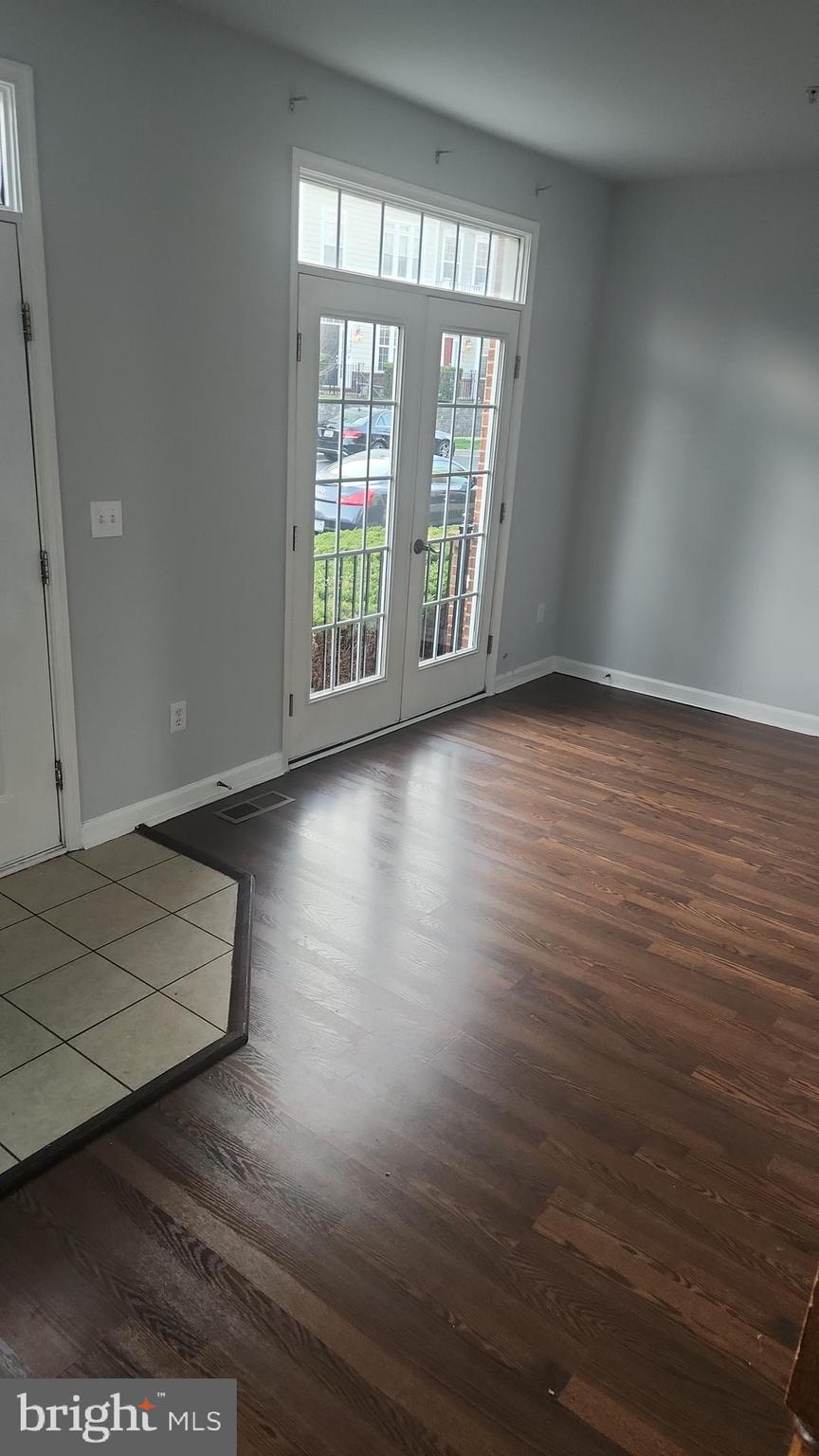 11612 Leesborough Circle Silver Spring, MD 20902 - Photo 29 of 29 an empty room with wooden floor and windows