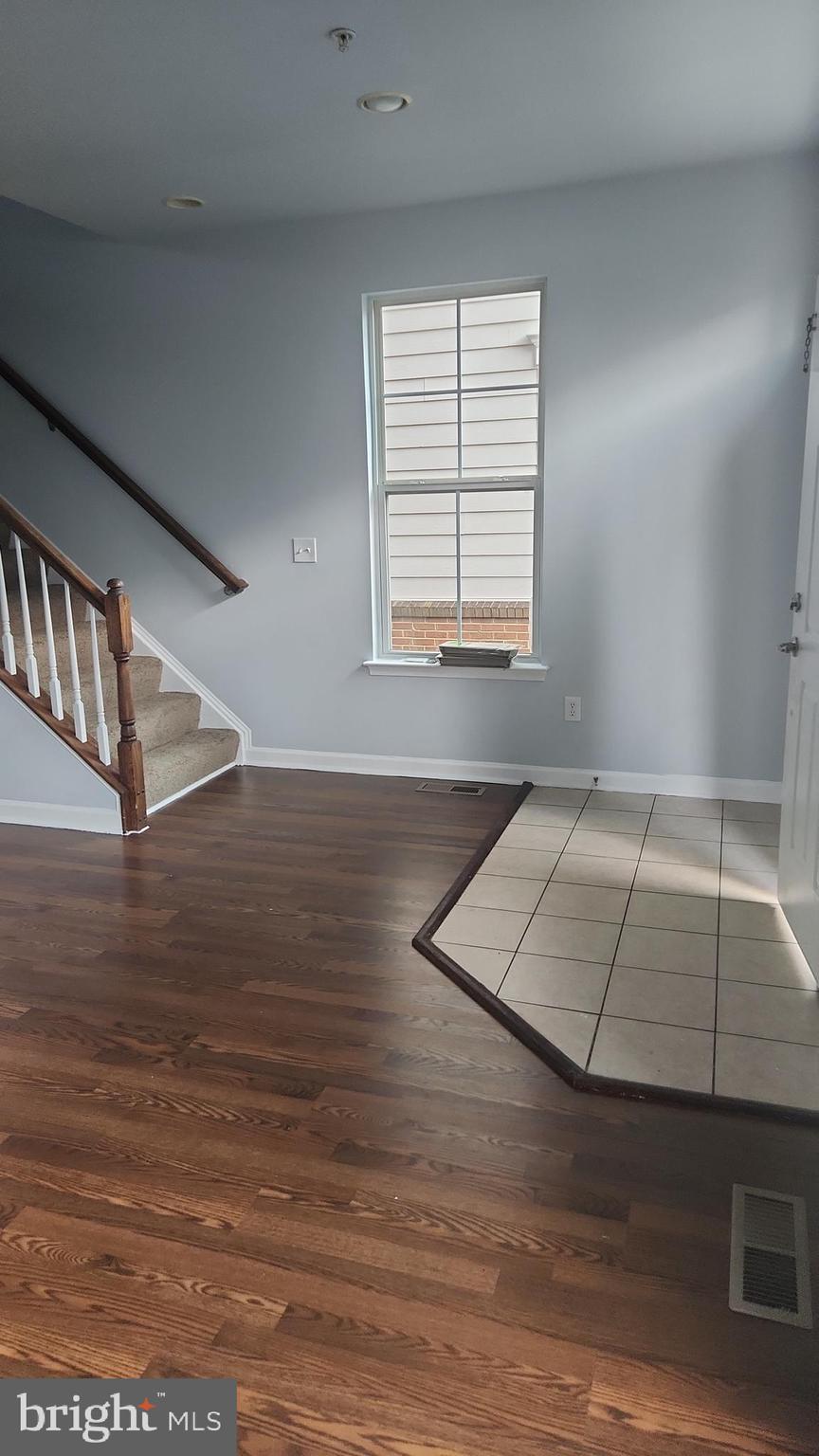 11612 Leesborough Circle Silver Spring, MD 20902 - Photo 5 of 29 an empty room with wooden floor and windows